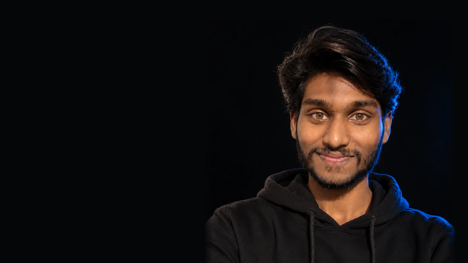 Blue-rimmed portrait of Vadla Hemanth.